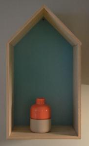 a red container sitting on a shelf with a green wall at Burdigala Homes - Appart de Lalande in Bordeaux