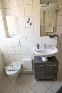 a bathroom with a toilet and a sink at Steffchen EG in Pruchten