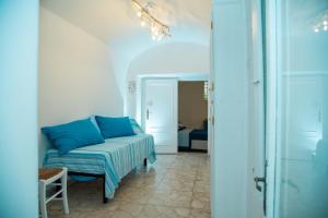 a living room with a blue couch in a room at Alaka Holiday Home in Gallipoli