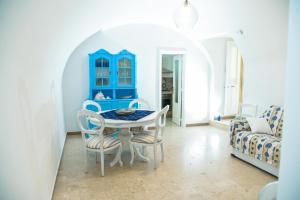 a blue dining room with a table and chairs at Alaka Holiday Home in Gallipoli