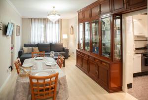 a living room with a table and a couch at Apartamento Maria Inmaculada in Santiago de Compostela