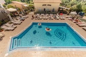a person swimming in a pool at a hotel at Solena Studios Kavos in Kavos +40 photos