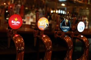 a row of wooden spoons with stickers on them at Green Lodge, Wirral by Marston's Inns in Hoylake