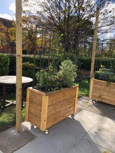 a wooden planter with a garden in it at Green Lodge, Wirral by Marston's Inns in Hoylake