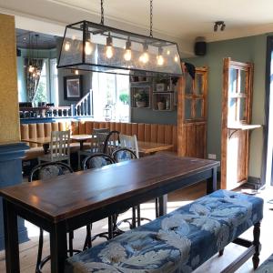 a dining room with a wooden table and chairs at Green Lodge, Wirral by Marston's Inns in Hoylake
