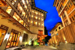 a large building with a lot of windows at night at The Pema by Realm in Thimphu