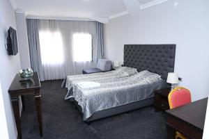 Postel nebo postele na pokoji v ubytování Hotel Emi