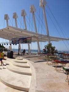 a group of tables and chairs on the beach at Studio El Faro in Torrox Costa