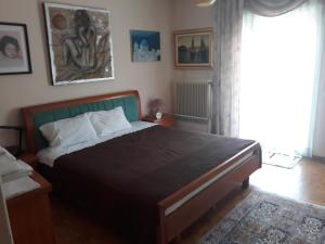 a bedroom with a large bed and a window at Villa Ioanna in Katerini
