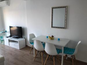 a living room with a table and chairs and a television at Sunset-Oase 4 in Prizna