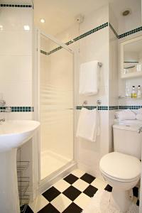 a bathroom with a shower and a toilet and a sink at The Daylesford Guest House in Torquay