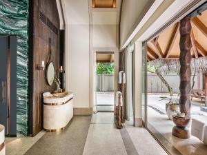 a bathroom with a sink and a mirror at JOALI Maldives in Raa Atoll
