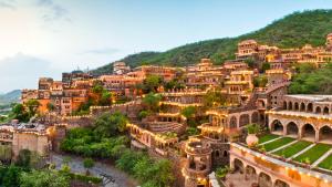 a town on a hill with houses and buildings at Neemrana Fort-Palace in Neemrana