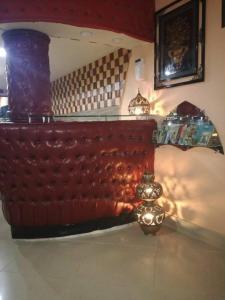 a bedroom with a couch and a clock on the floor at Hotel City View Peshawar in Peshawar