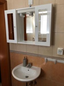 a bathroom with a sink and a mirror at Apartman Sena in Vodice +31 photos