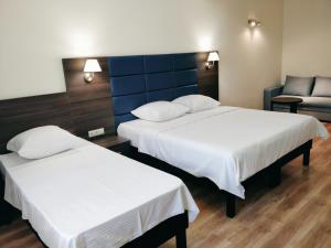 Łóżko lub łóżka w pokoju w obiekcie Hotel Kapitan Morey