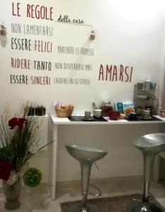 a kitchen with two stools in front of a counter at B&B Liberty in Santa Maria Capua Vetere