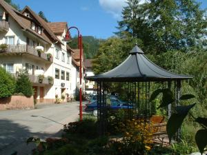 a gazebo in the middle of a street next to a building at Adieu Alltag: Pension Oesterle im Schwarzwald in Schönmünzach