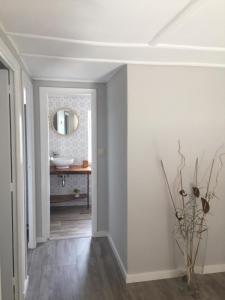a hallway with a bathroom with a sink and a mirror at Casa Labazá in Villarmayor