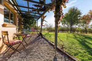 a patio with a table and chairs in a yard at Rosby Guesthouse and Studio in Eurunderee