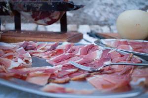 a plate of food with ham on a table at Charme in Perillis in Popoli