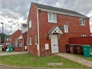 a red brick house with a white door at WHOLE HOUSE with 3bedrooms New Build Nottingham 29 in Nottingham