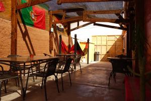 a patio area with tables, chairs and umbrellas at Hostal Campo Base in San Pedro de Atacama