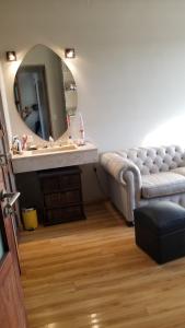 a living room with a couch and a mirror at RENTAL FLAT BOUTIQUE PILAR in Pilar