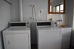 a kitchen with two washers and a dishwasher at Best Western Bundaberg City Motor Inn in Bundaberg