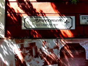 a sign on the side of a building at MonAmi Art Apartman in V&aacute;c