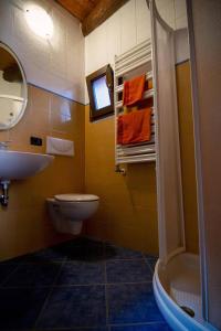a bathroom with a sink and a toilet and a shower at Piccola casa vacanze - Small vacation house in Porto Valtravaglia