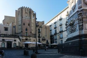 a city street with buildings and a clock tower at B&B La Canzanella in Naples