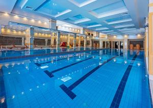 a large swimming pool with a large blue pool at 7 Pools SPA Boutique Hotel in Bansko