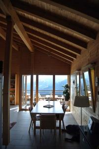 a dining room with a table and a view of the ocean at Chalet Oberbörtji Furna in Furna