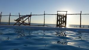 a view of the beach and the pier at villa sur la plage et piscine in Mahajanga