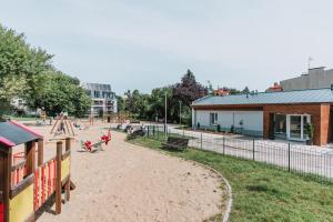 a park with a playground and a building at Dom gościnny Luk Luk in Sopot