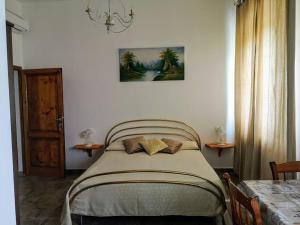 a bedroom with a bed with two pillows on it at La California in Marina di Bibbona
