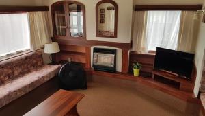 a living room with a couch and a television at Bolęcińskie Zacisze- NOCLEGI, okolice Zator in Bolęcin