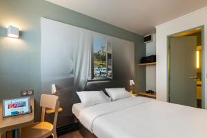 Katil atau katil-katil dalam bilik di B&B HOTEL Angers 1 Beaucouzé