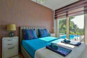 a bedroom with a bed with two towels on it at Lux Apartment Luna in Sveti Stefan