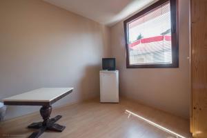 an empty room with a table and a window at Стаи за гости АЯКС Guest rooms AJAX in Kranevo +17 photos