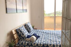 a bedroom with a bed with a chair and a window at Casa Bella Vista en montaña con vistas al mar y piscina privada in Cunit +42 photos