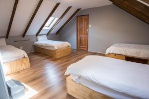 a attic bedroom with two beds and a skylight at Atlantic Point Backpackers in Cape Town