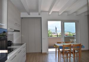 a kitchen with a table and chairs and a window at Villa Dina in Riva del Garda