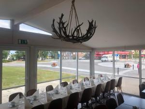 a dining room with tables and chairs and a chandelier at CityBed Bed & Breakfast in Pajala