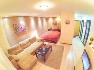 a living room with a couch and a bed at Apartment on Lenin Avenue in Gomel
