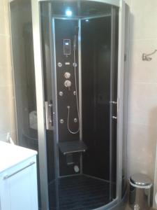 a shower with a glass door in a bathroom at La Résidence de Lorelei in Cierp