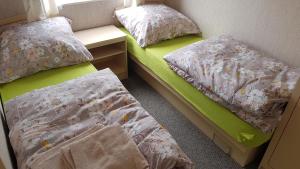 a room with two beds and a night stand and a bedskirts at Bolęcińskie Zacisze- NOCLEGI, okolice Zator in Bolęcin