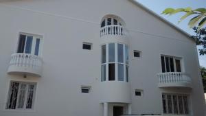 a white building with two balconies on it at Villa House Georgia in Tbilisi City