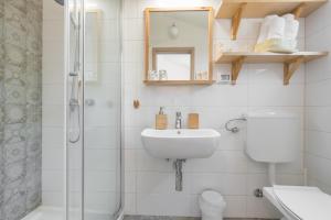 a bathroom with a shower and a sink and a toilet at B&B Carmela in Umag